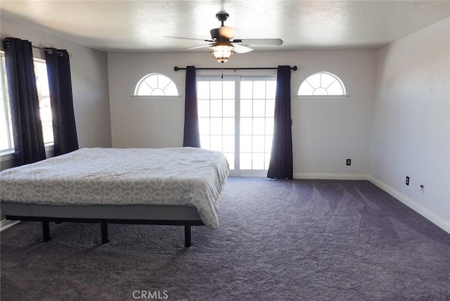 carpeted bedroom with multiple windows, baseboards, and a ceiling fan