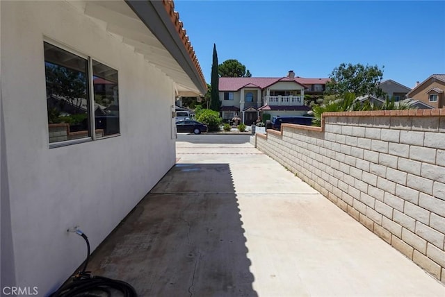 view of home's exterior featuring a residential view, stucco siding, and a patio area