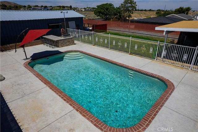 view of pool featuring a patio area, fence, and a fenced in pool