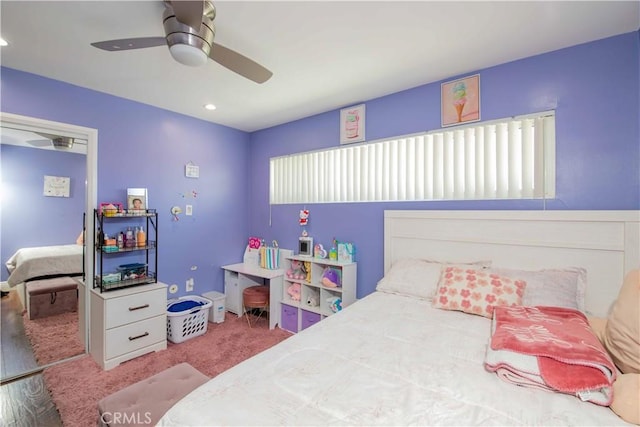 carpeted bedroom with a ceiling fan, multiple windows, and recessed lighting