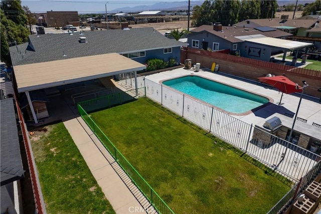 view of pool with a residential view, a patio area, a fenced backyard, a yard, and a fenced in pool