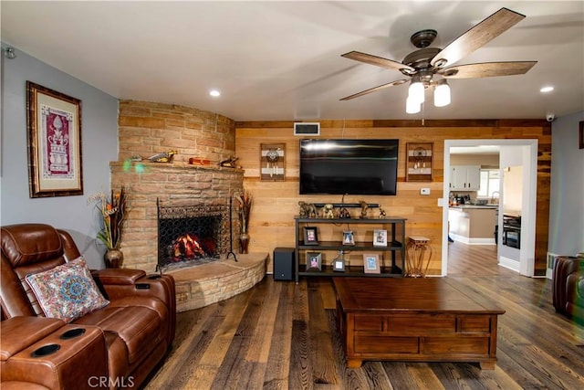 living room with a ceiling fan, recessed lighting, visible vents, wood finished floors, and a fireplace