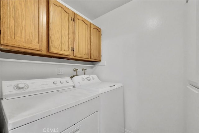 laundry room featuring cabinet space and washer and dryer