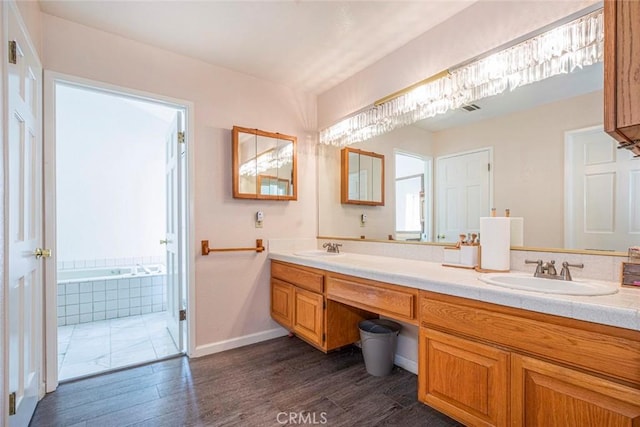 9653 La Tuna Canyon Rd, Sun Valley, CA 91352 - bathroom with double vanity, wood finished floors, baseboards, and a sink