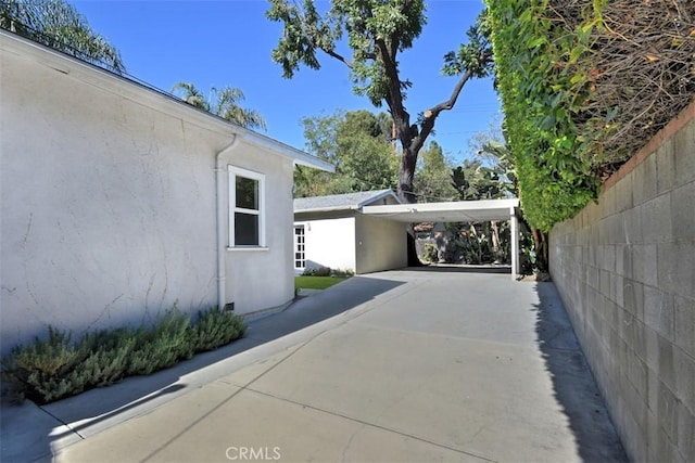 view of property exterior featuring driveway and stucco siding