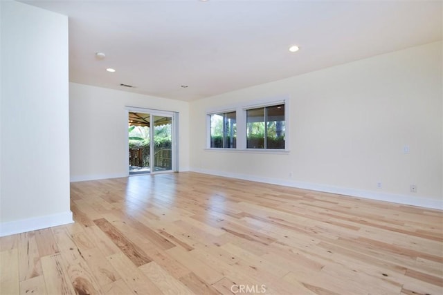 unfurnished room featuring light wood-style flooring, baseboards, and recessed lighting