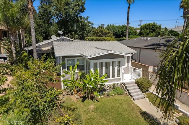 10633 Chiquita St, Toluca Lake, CA 91602 - back of house featuring a shingled roof and a yard