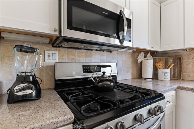 10633 Chiquita St, Toluca Lake, CA 91602 - kitchen featuring stainless steel appliances, white cabinets, and backsplash