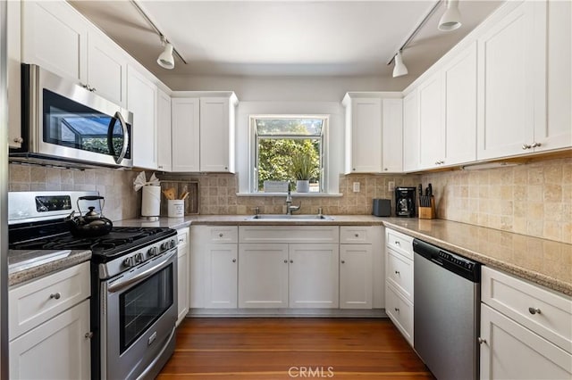10633 Chiquita St, Toluca Lake, CA 91602 - kitchen featuring appliances with stainless steel finishes, track lighting, a sink, and white cabinets