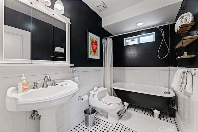 10633 Chiquita St, Toluca Lake, CA 91602 - bathroom featuring tile walls, a tub, wainscoting, toilet, and a shower with curtain