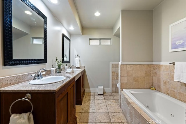 10633 Chiquita St, Toluca Lake, CA 91602 - bathroom with baseboards, a jetted tub, double vanity, recessed lighting, and stone tile flooring