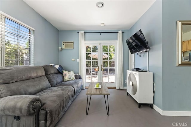 10633 Chiquita St, Toluca Lake, CA 91602 - living room featuring french doors, a wall unit AC, and baseboards