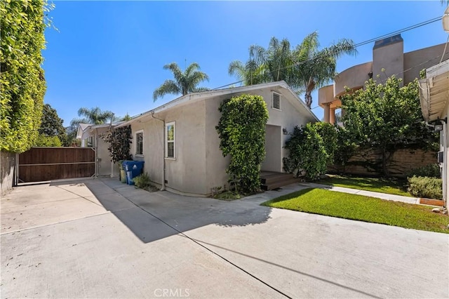10633 Chiquita St, Toluca Lake, CA 91602 - view of side of property with stucco siding, fence, and a gate