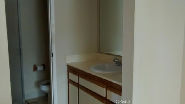 bathroom with toilet and vanity