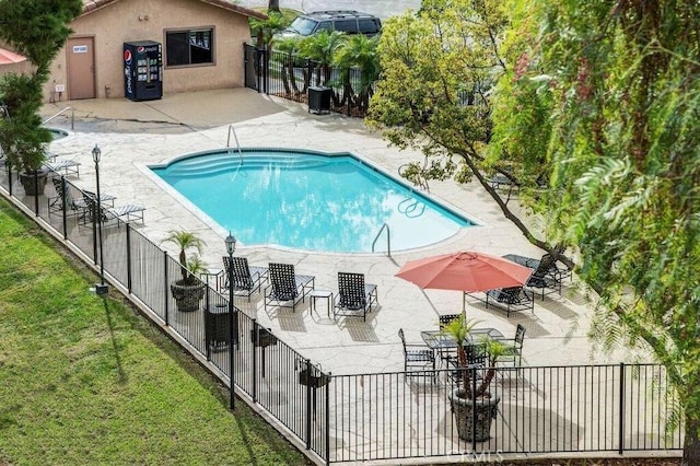 pool with a patio area, fence, a lawn, and central AC unit