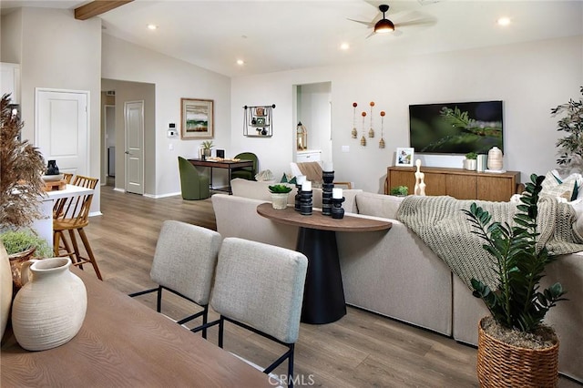 living room featuring a ceiling fan, recessed lighting, baseboards, wood finished floors, and vaulted ceiling with beams
