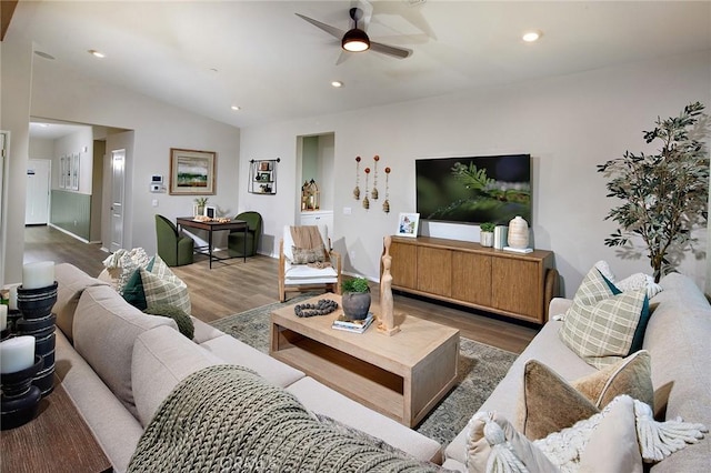 living room with vaulted ceiling, recessed lighting, a ceiling fan, and wood finished floors