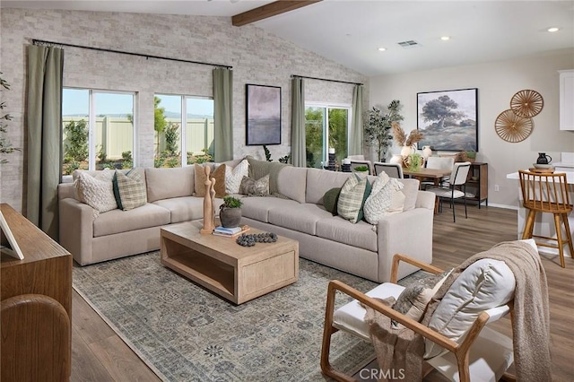 living area featuring lofted ceiling with beams, wood finished floors, visible vents, recessed lighting, and baseboards