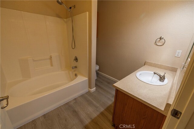 41410 Juniper St Unit 1711, Murrieta, CA 92562 - bathroom featuring toilet, wood finished floors, washtub / shower combination, baseboards, and vanity