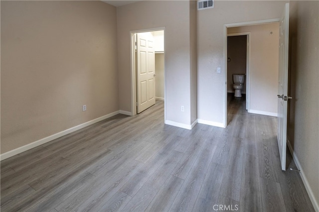 41410 Juniper St Unit 1711, Murrieta, CA 92562 - unfurnished bedroom with baseboards, visible vents, and wood finished floors