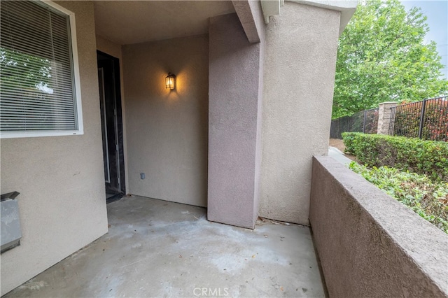 view of patio / terrace with fence and a balcony