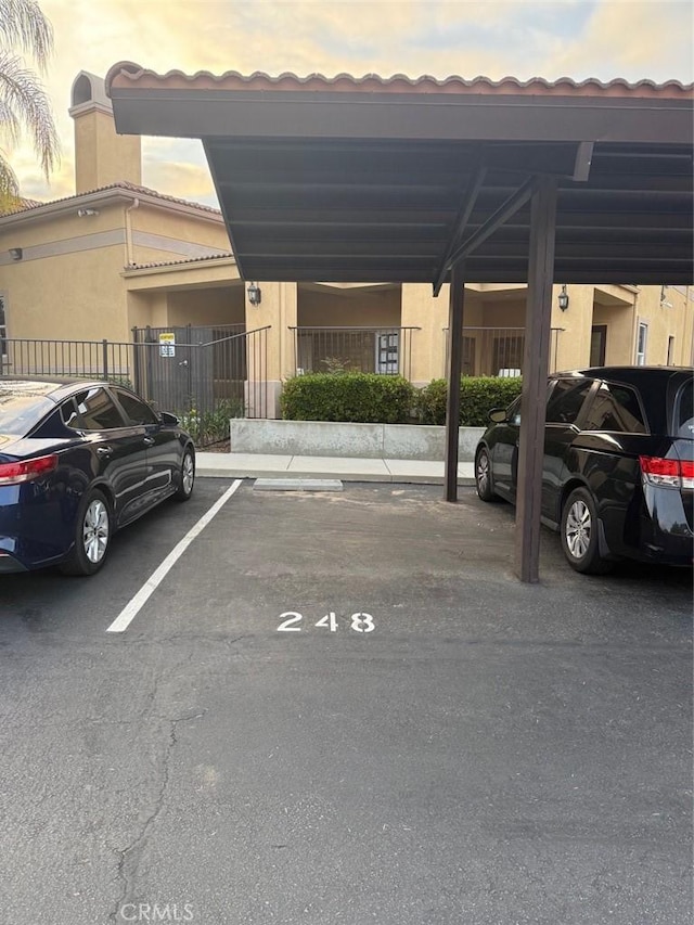 41410 Juniper St Unit 1711, Murrieta, CA 92562 - parking at dusk featuring covered and uncovered parking and fence
