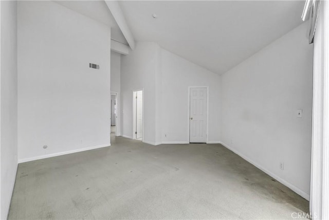 empty room featuring carpet, visible vents, baseboards, and high vaulted ceiling
