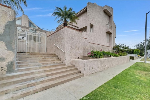 3853 W 182nd St, Torrance, CA 90504 - view of side of property with stucco siding and a yard
