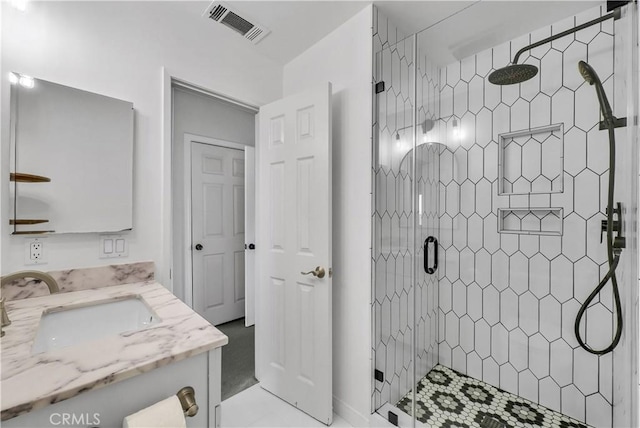 bathroom with vanity, visible vents, and a shower stall