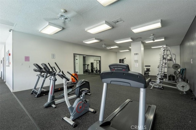 workout area featuring a textured ceiling and visible vents