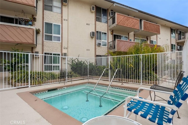view of pool featuring fence