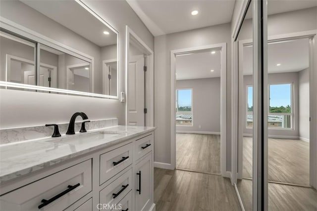bathroom featuring recessed lighting, baseboards, and wood finished floors