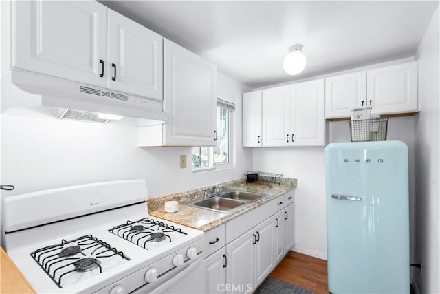 6023 Acacia Ave, Whittier, CA 90601 - kitchen with white appliances, under cabinet range hood, a sink, light countertops, and white cabinetry