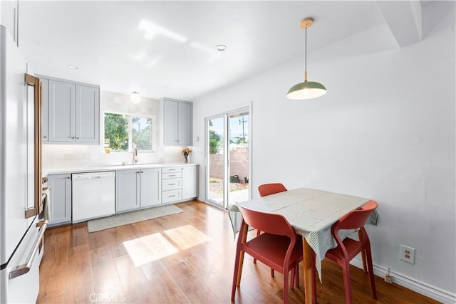 6023 Acacia Ave, Whittier, CA 90601 - kitchen featuring white appliances, a sink, light wood-style flooring, and gray cabinetry