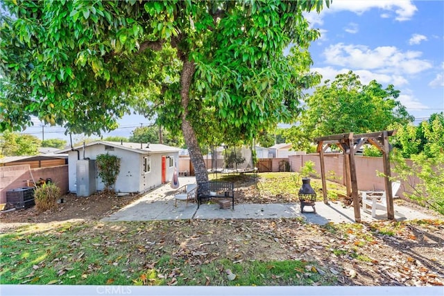 6023 Acacia Ave, Whittier, CA 90601 - fenced backyard featuring a trampoline, a patio area, and central AC