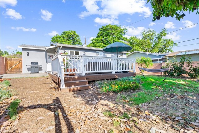 6023 Acacia Ave, Whittier, CA 90601 - back of property featuring a wooden deck, fence, a gate, and stucco siding