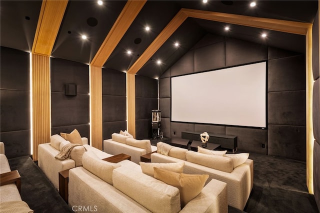 cinema featuring dark colored carpet and high vaulted ceiling