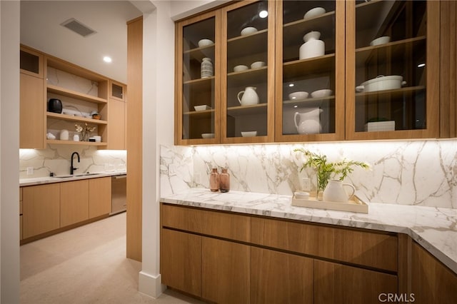 interior space featuring a sink, stainless steel dishwasher, visible vents, light colored carpet, and decorative backsplash