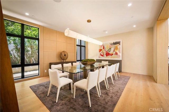 dining space with light wood-type flooring and recessed lighting
