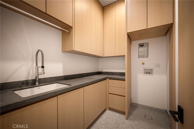 clothes washing area featuring cabinet space, washer hookup, and a sink