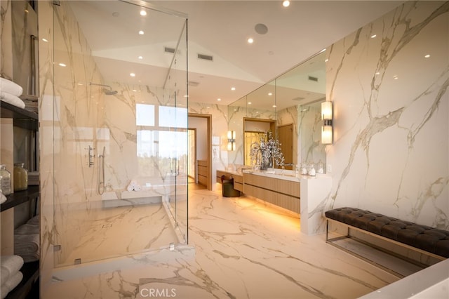 full bathroom featuring stone wall, marble finish floor, vanity, a marble finish shower, and recessed lighting
