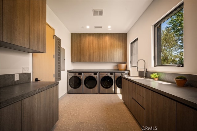 washroom featuring a sink, separate washer and dryer, a wealth of natural light, and cabinet space