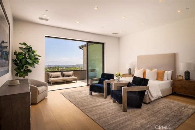 bedroom with recessed lighting, visible vents, access to exterior, and wood finished floors