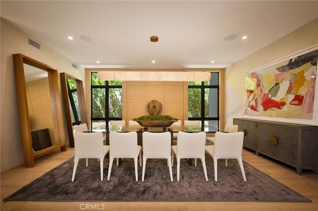 dining room featuring a wealth of natural light, visible vents, wood finished floors, and recessed lighting