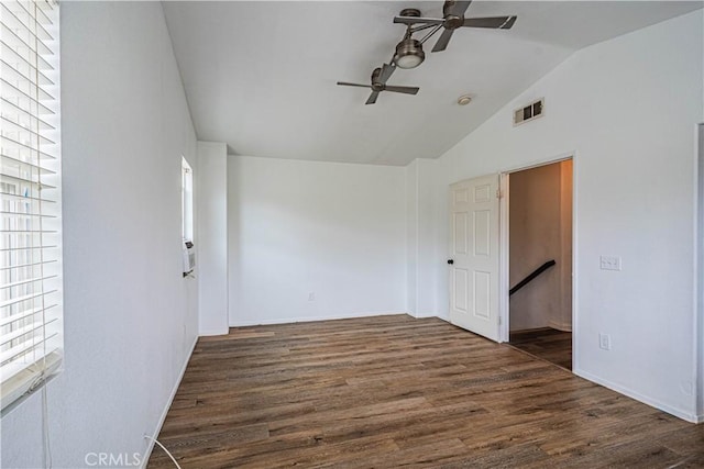 spare room featuring vaulted ceiling, baseboards, visible vents, ceiling fan, and wood finished floors