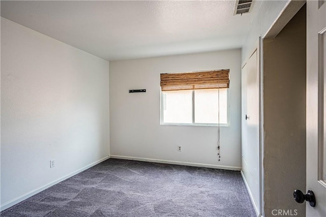 spare room featuring visible vents, baseboards, and carpet floors