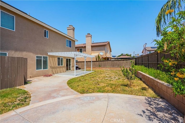 view of yard featuring a patio area, a pergola, and a fenced backyard