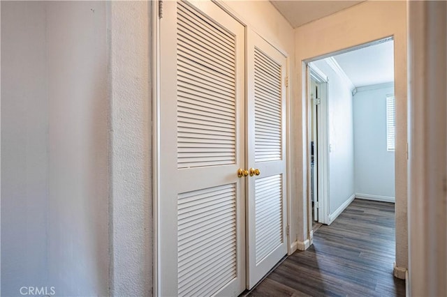 hall with baseboards and dark wood finished floors