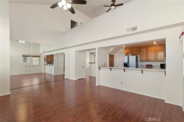 4839 W Forest Oaks Ave, Banning, CA 92220 - unfurnished living room with a ceiling fan, dark wood-style flooring, a high ceiling, and baseboards