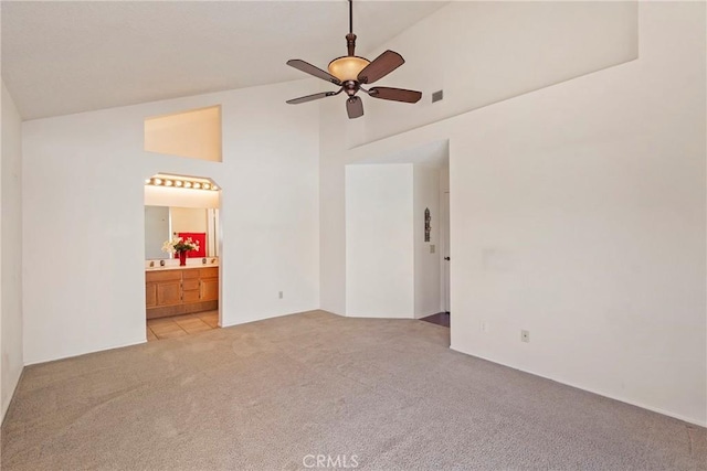 4839 W Forest Oaks Ave, Banning, CA 92220 - empty room featuring light carpet, a ceiling fan, and high vaulted ceiling